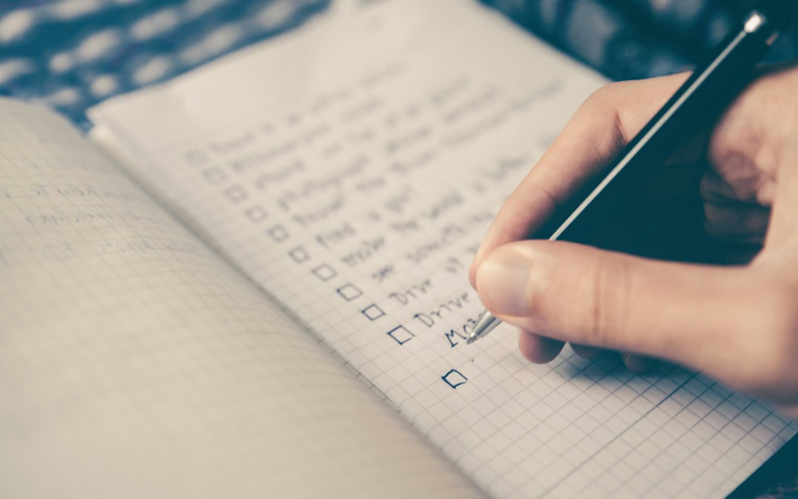 A hand checking off the next step on a list